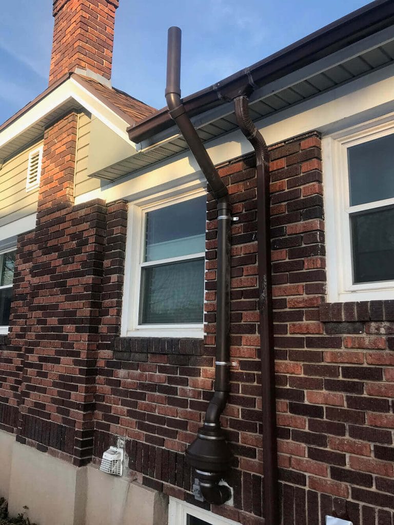 A Painted Radon Mitigation System Installed on Brick House in Utah